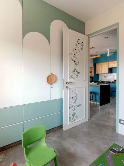 Even the door to the kids' room is playful, with peek-a-boo animal illustrations that hint at the fun inside.