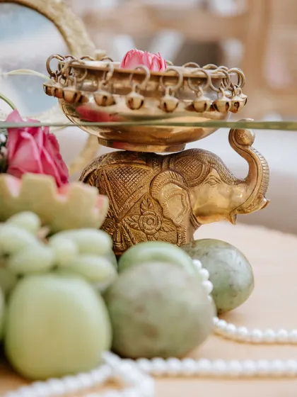 A close-up of the ornate brass elephant holding a bowl with a floating lotus, a nod to traditional Indian artistry.