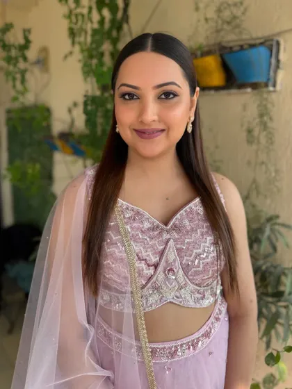 Another angle of the bride in her lilac lehenga, showcasing the versatility of the soft glam look in different lighting.