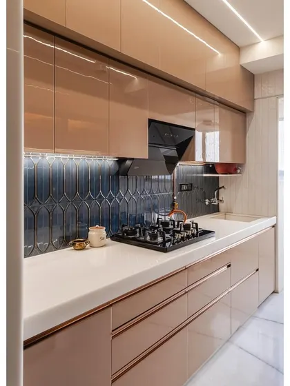 A detailed shot of the cooking zone. The white countertop provides a bright and durable work surface, and the under-cabinet lighting ensures the area is well-lit for food preparation. The blue tiles add a touch of designer flair.