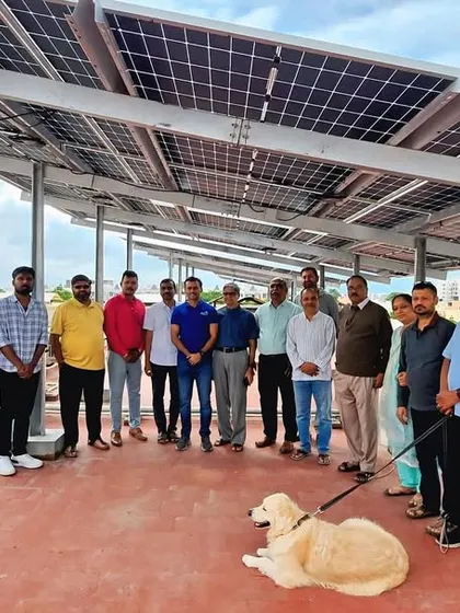 The residents and committee members of Shivaprakruthi Society in Bangalore, along with a furry friend, celebrating their new 30 kW rooftop solar system.