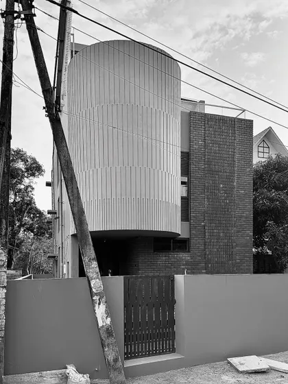 Work-in-progress photos from another residence in Thrissur, showing the raw beauty of the structure with its curved brick walls and complex interior staircases.