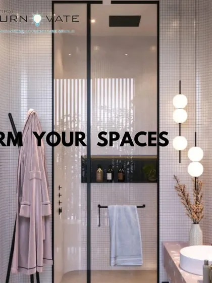 Another view of the stylish pink bathroom, showing the glass shower partition and black fixtures that provide a modern contrast to the soft color palette.