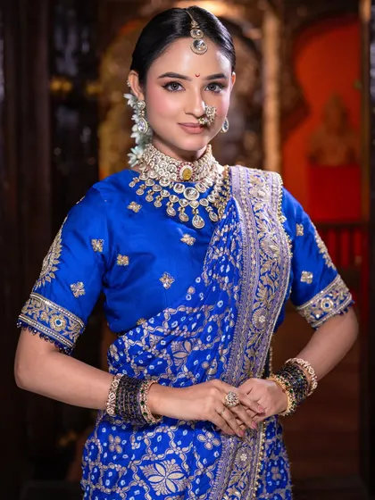 This look is all about grace and tradition. The soft makeup allows the rich blue of the saree and the intricate jewelry to take center stage.