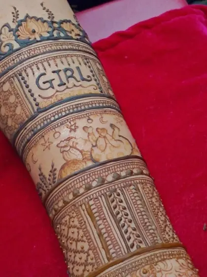 This shot shows the full arm design for the baby shower mehendi. The combination of text, illustrations, and traditional patterns makes it a truly special piece.