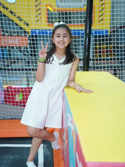 A happy girl strikes a pose, enjoying her time at Wobble World.
