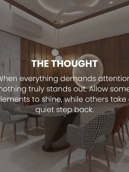 A dining area where a bold houndstooth pattern on the chairs is balanced by the simple, elegant wood paneling and a modern light fixture. We believe in letting some elements shine while others provide quiet support.