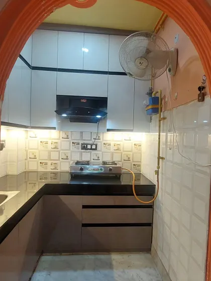 A view of the small kitchen from the entrance, showing how we maximized the space to create a practical and visually appealing cooking area.