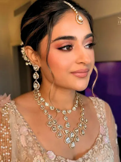 A bridal vision in soft hues. This bride glows in our delicate Polki necklace set, featuring uncut diamonds that offer a subtle, yet breathtaking, sparkle for her big day.