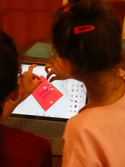 Two students collaborate on a 3D design, showing the teamwork and creativity that our programs foster.