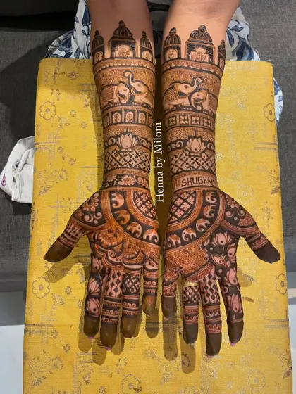 A beautiful bridal mehendi with a focus on elephant motifs. The design includes the groom's name, "Shubham," for a personal touch.