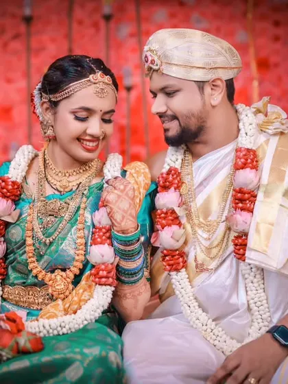 A sweet candid moment captured during the wedding rituals, with the couple sharing a private smile.