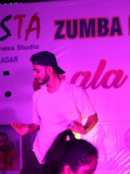Lost in the music and movement on stage at the Fiesta event. The pink lighting adds to the vibrant, party-like atmosphere of our Zumba nights.