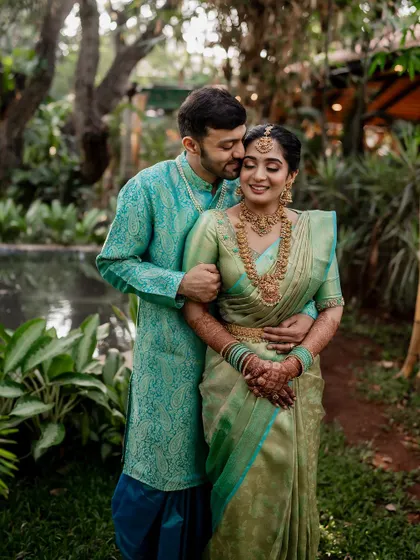 A tender moment between the couple, showcasing their beautiful coordinated outfits. Our goal is to capture the subtle emotions and details that make your wedding portraits special.
