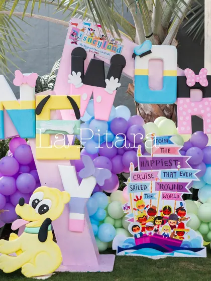 Large, colorful letters spelling 'MICKEY' with Pluto, part of the vibrant decor for a Disneyland-themed event.