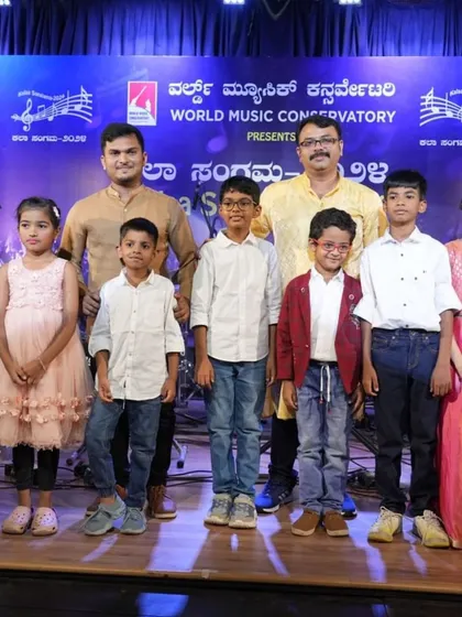 Our keyboard students and their dedicated teachers, Dr. Shyam Sundar Dage and Siddu, posing after a successful group performance. This picture captures the joy and camaraderie of our musical family.