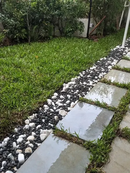 The wet stone slabs after a light watering, highlighting their natural color and texture.