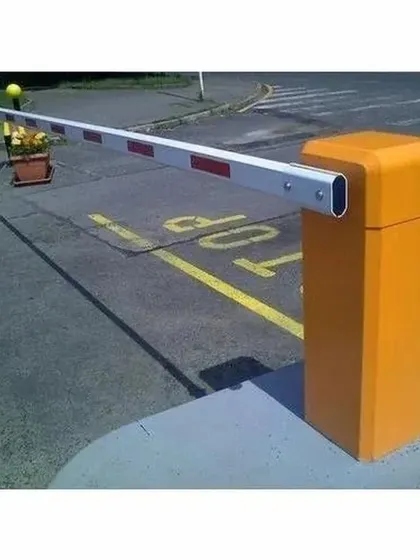 A heavy-duty boom barrier installed to manage vehicular traffic at an entry point. These systems are essential for controlling access in parking lots, corporate campuses, and residential communities.