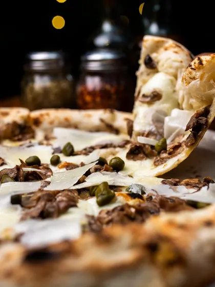 A pizza slice a day keeps the Monday blues away. Especially a slice of our Pizza Bianca Funghi e Capperi.