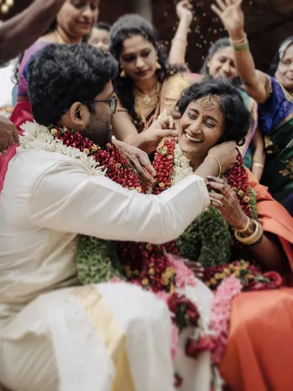Surrounded by family, the couple shares a laugh as they are showered with petals. This is the essence of my candid photography style, capturing the real, joyful vibe of the celebration.