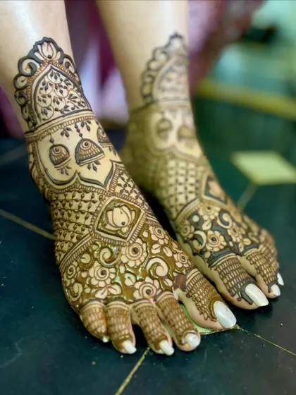 A beautiful bridal feet design with a mix of floral, lotus, and jhumka motifs.