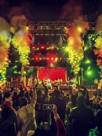 A spectacle of light, sound, and soul. The grand stage at Rajdanga Pithe Puli Utsav, with pyrotechnics lighting up the sky as the crowd sings along.