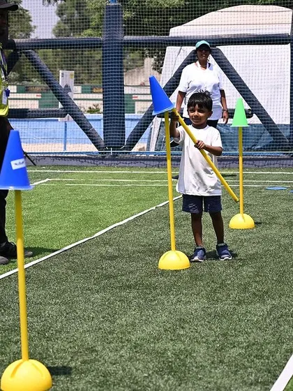 A student navigates a slalom course, a great activity for developing coordination and gross motor skills.