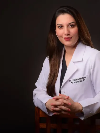 A seated variation of the doctor's portrait. This pose is often used to appear more grounded and thoughtful in professional profiles.