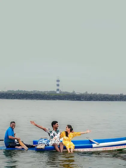 An adventurous pre-wedding shoot on a boat off the Pondicherry coast, with the lighthouse in the distance.