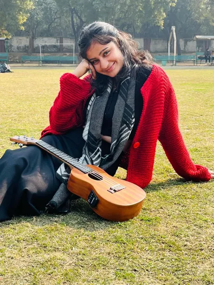 Relaxing with my ukulele after a little practice session outdoors. I find inspiration for my music all around me.