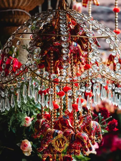For this Varapuja ceremony, we used a vibrant palette of reds and pinks. The decor included hanging elephant charms and a mirrored backdrop to create a festive and prosperous atmosphere.