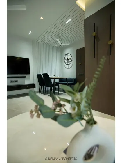 A different angle of the Tulsi Heights dining nook, showing its relationship to the TV unit and the rest of the living space. The design ensures a cohesive look throughout the open-plan area.