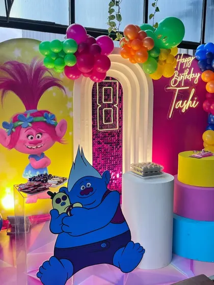 A different angle of the Trolls setup, showing the neon number "8" and personalized "Happy Birthday" sign.