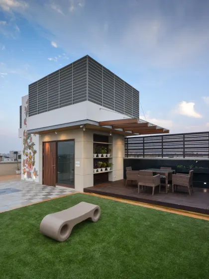 The third floor of Kavyam Residence features this breezy terrace garden. The guest room gently spills into the terrace, where a light tensile roof offers shade, creating a calm, open space to unwind and connect with nature.