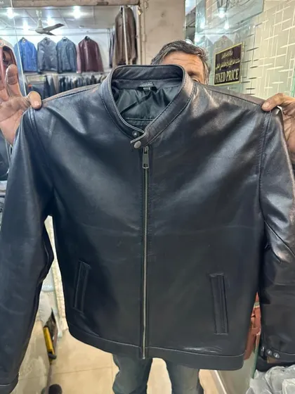 A classic men's leather jacket in black with a central zip and stand up collar. This is a timeless piece, sourced from a trusted leather goods shop in Karachi.
