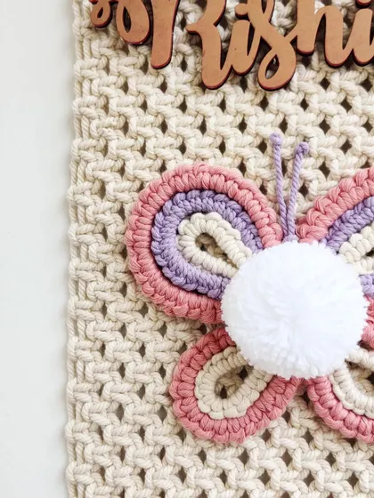 A close-up of the pretty pastel butterfly and the wooden name cutout.