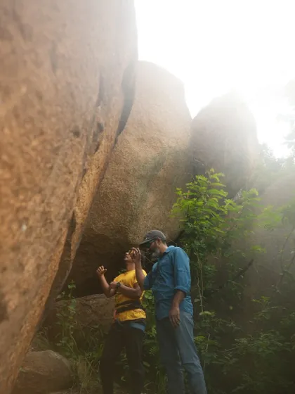 Two climbers discussing beta before a climb. Sharing knowledge and encouraging each other is a core part of our community's spirit.