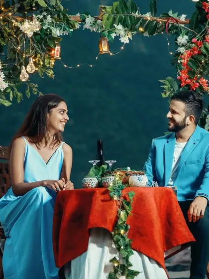 A romantic pre-wedding date setup on the banks of the Ganga, complete with a decorated table and floral arch. I can help arrange these special setups to make your shoot even more memorable.