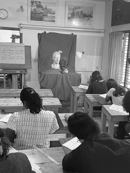 Students work diligently during an exam, sketching a bust setup. This practice tests their understanding of form, light, and shadow, which are core components of our sketching foundation course.