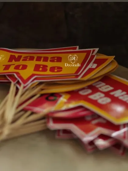 Fun props for the grandparents-to-be, with "Nana to Be" and "Nani to Be" flags.