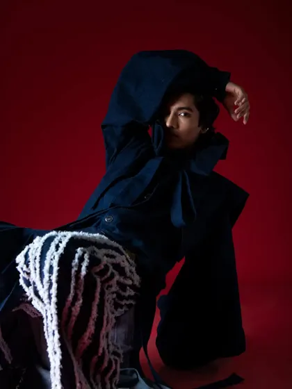 Creating movement and drama within a studio space. This pose highlights the volume of the sleeves and the texture of the pants.