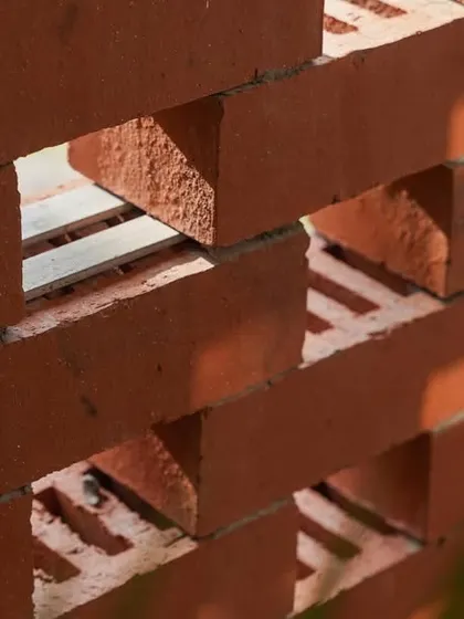 A detailed close-up of the brick jali, showing the clean lines and precise gaps that create the screen effect.