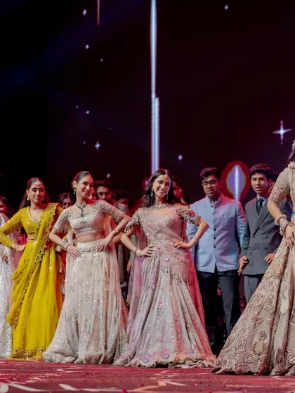 A fun moment where the bride and groom are playfully quizzed by the bridesmaids during a performance. Interactive elements like this make the sangeet more engaging.