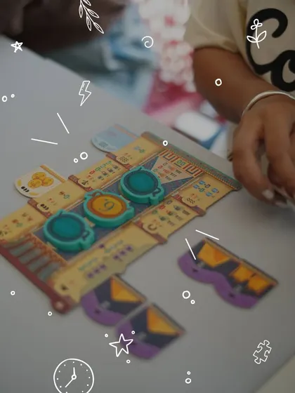 A close-up of the action. A player makes a strategic move in one of the many modern board games we explore. It's all about figuring things out together and enjoying the process.