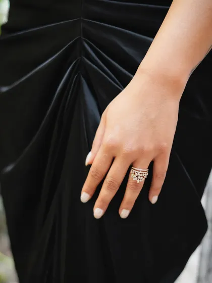 A detail shot of the bride's hand, showing off her engagement ring and elegant manicure, a small but important part of her cocktail party look.