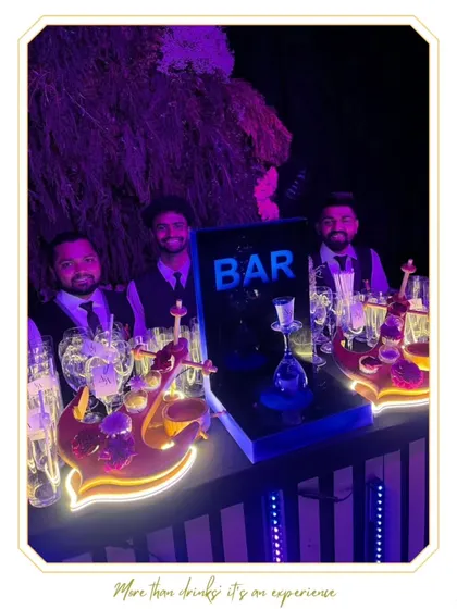Our team ready for service at a bar featuring unique, anchor-shaped shot holders and a central hookah station. The setup is designed for both visual impact and guest interaction.