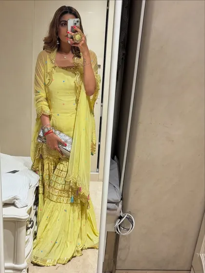 A mirror selfie of one of my Ganpati looks. This yellow sharara set is bright, festive, and comfortable for a long day of celebrations.