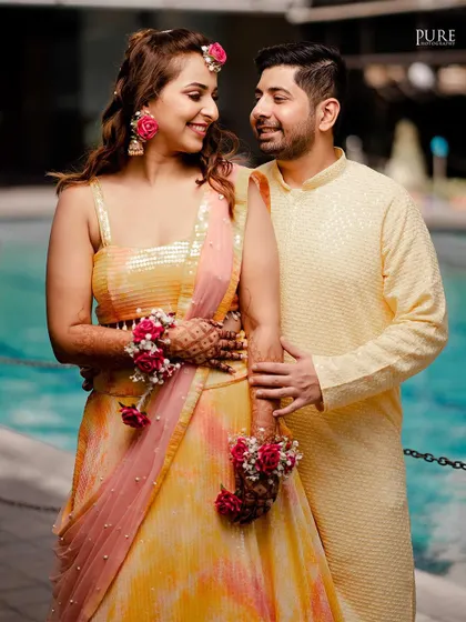 A lovely portrait of the couple at their Haldi ceremony. Their coordinated yellow outfits and happy expressions are perfect.