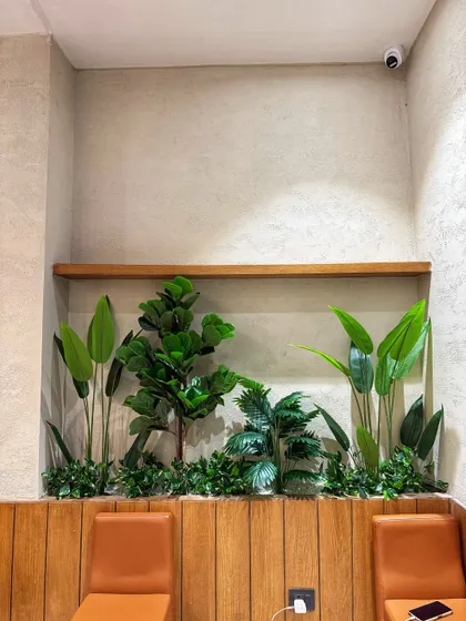 A detailed look at the built-in planter at Looks Salon. We used a variety of artificial plants with different leaf shapes and heights to create a dense, textured, and realistic-looking arrangement.