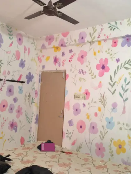 A wider view of the playful floral bedroom, showing how the pattern wraps around the room.